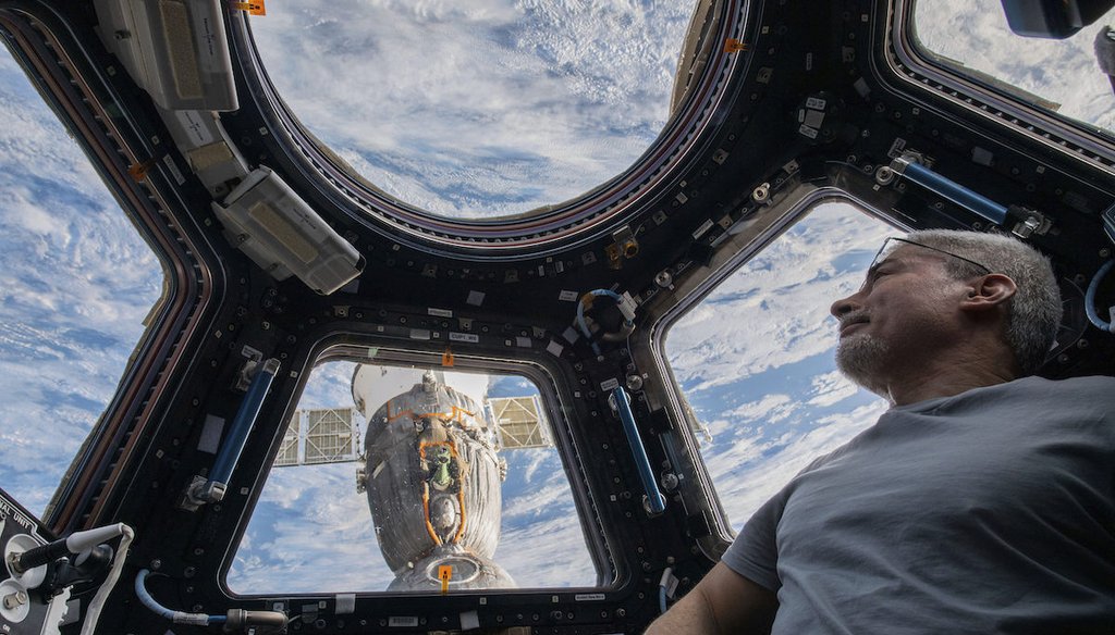 In this Feb. 4, 2022, file photo, U.S. astronaut and Expedition 66 Flight Engineer Mark Vande Hei peers at the Earth from inside the seven-windowed cupola, the International Space Station's window to the world. (Kayla Barron/NASA via AP)