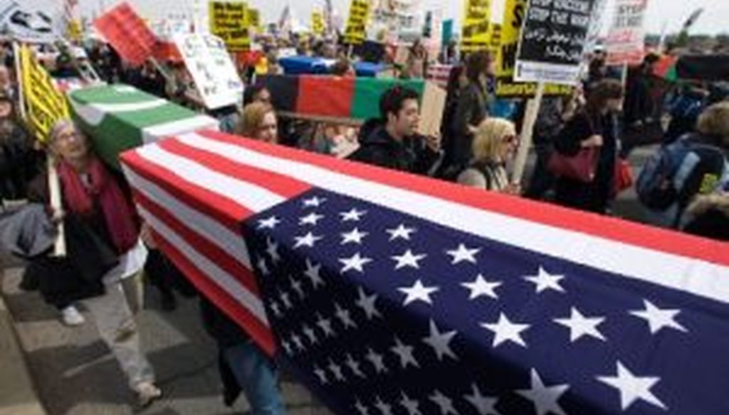 Anti-war protesters carry mock coffins draped in American flags during a march to the Pentagon on March 21, 2009, marking the sixth anniversary of start of the war in Iraq.
