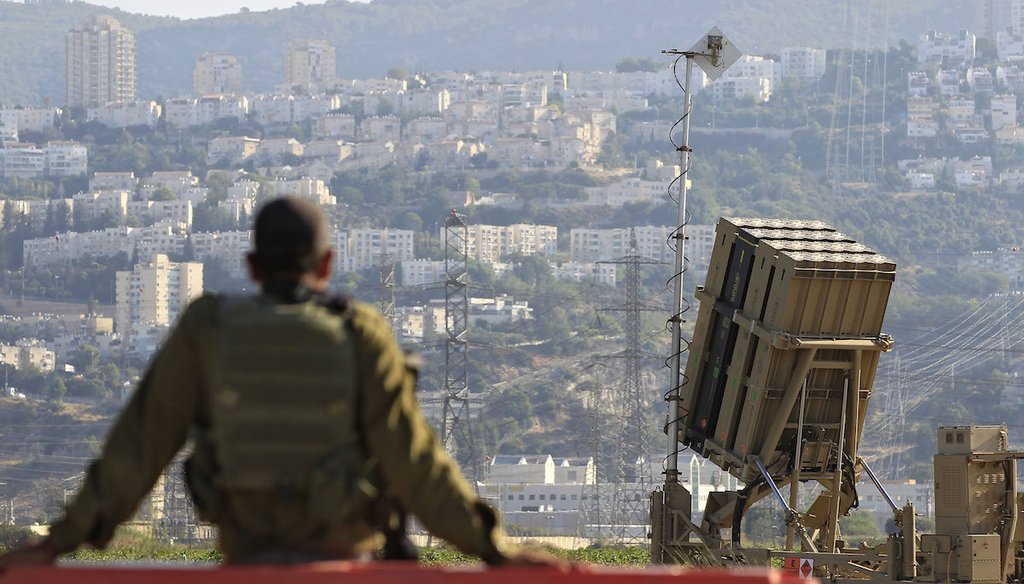 In this 2013 file photo, an Israeli soldier is seen next to an Iron Dome rocket interceptor battery. The laser-defense system called the "Iron Beam" was first unveiled in 2014. (AP)