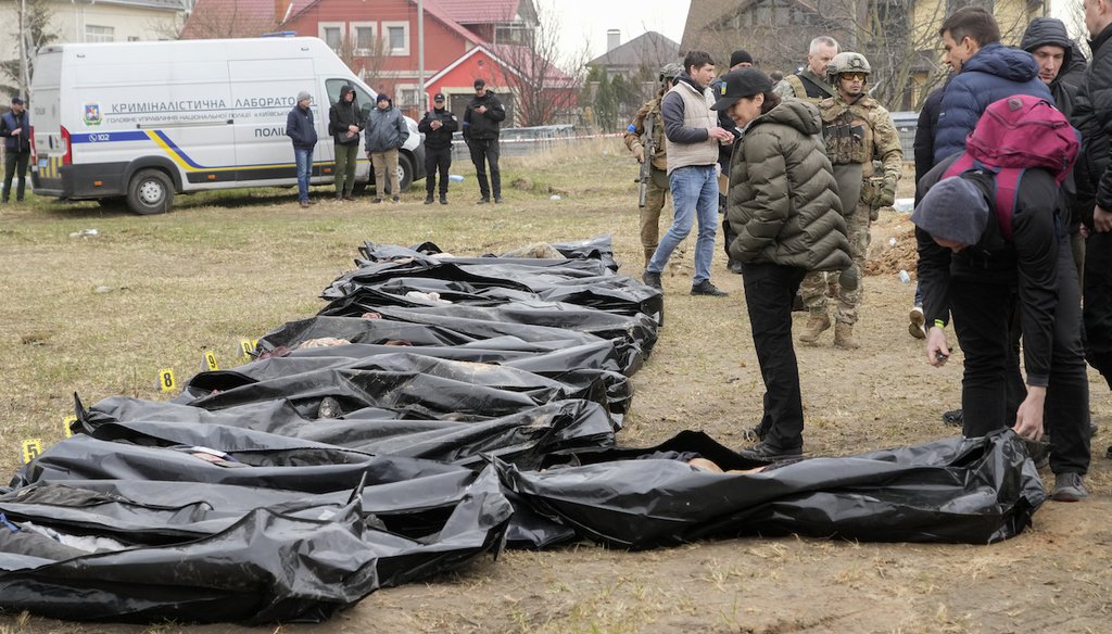 Ukrainian Prosecutor General Iryna Venediktova, center, looks at the exhumed bodies of civilians killed during the Russian occupation in Bucha, on the outskirts of Kyiv, Ukraine, on April 8, 2022. (AP)