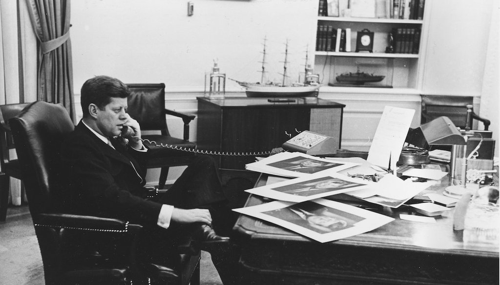 President John F. Kennedy is shown as he ends his official day after 7:30 pm with a final phone call to his press secretary from his Oval Office desk at the White House in Washington, D.C., March 16, 1961. (AP)