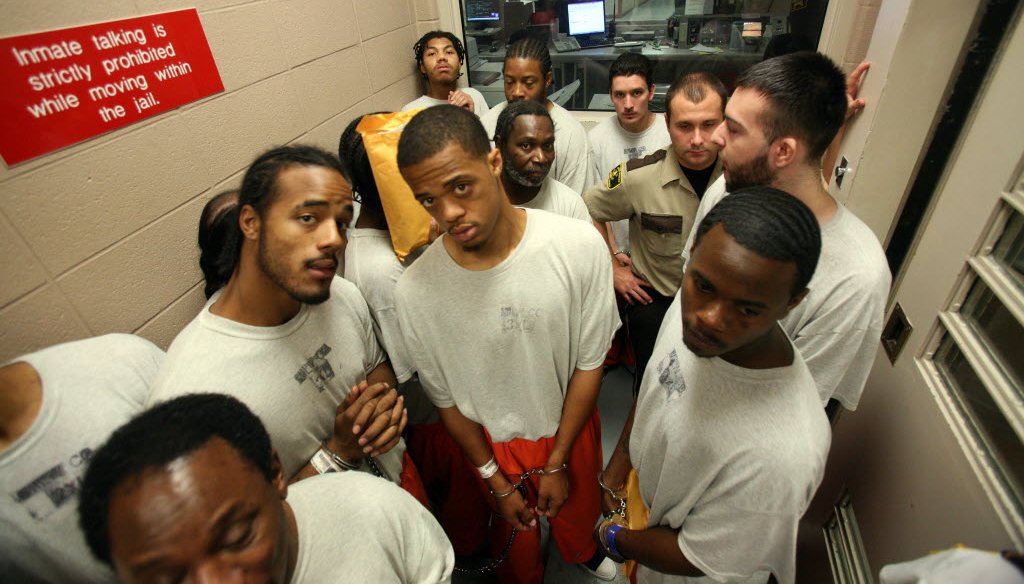 Inmates arriving from the House of Correction wait for a door to open before heading to the court staging area at the Milwaukee County Jail. They were scheduled for afternoon court hearings. (Mark Hoffman photo)