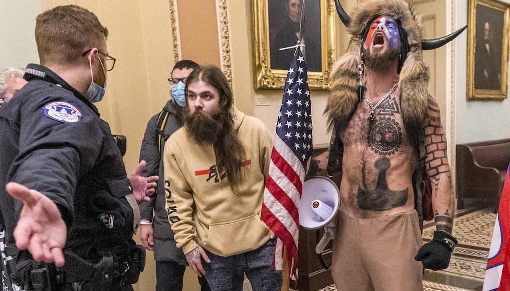 Supporters of then-President Donald Trump, including Jacob Chansley, right with fur hat, are confronted by U.S. Capitol Police officers outside the Senate Chamber inside the Capitol in Washington on Jan. 6, 2021. (AP)
