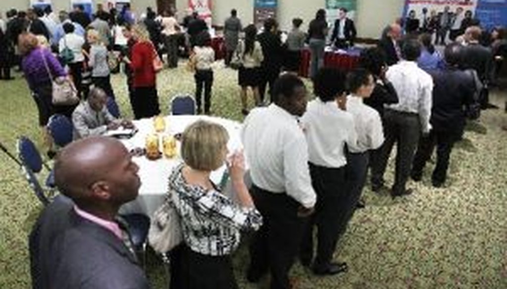 Job seekers line up in front of booths at a career fair in Arlington, Va., on Aug. 4, 2011. One day later, President Barack Obama got some good news on job creation.