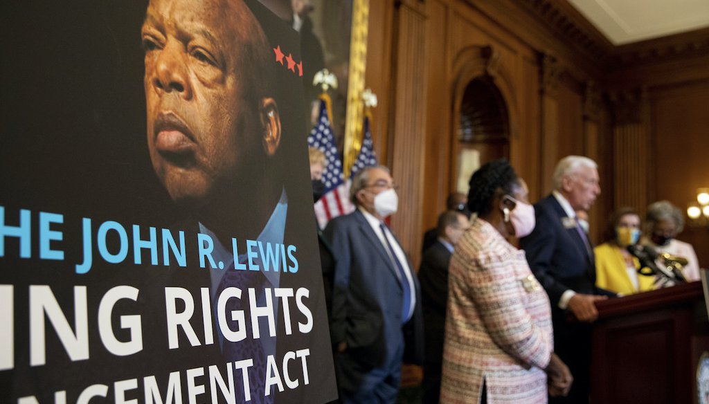 A poster bearing the image of voting rights icon John Lewis is seen during a news conference after the House of Representatives passed the The John Lewis Voting Rights Advancement Act in Washington, on Capitol Hill in Washington, on Aug. 24, 2021. (AP)