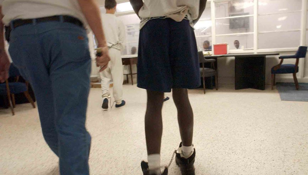 Teenage offenders are led shackled into the C.A. Dillon Youth Development Center in Butner, N.C., in 2003. News & Observer photo.