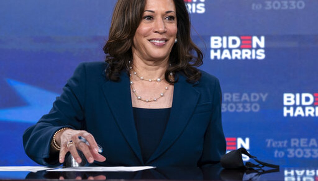 Democratic presidential candidate former Vice President Joe Biden's running mate Sen. Kamala Harris, D-Calif., looks up as she signs required documents for receiving the Democratic nomination for President and Vice President of the United States in Wilmin