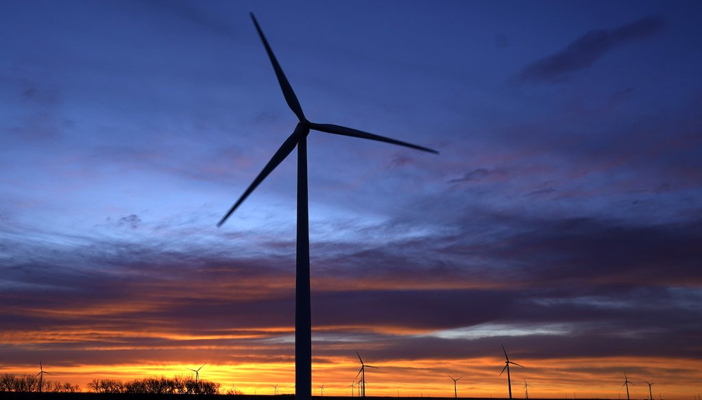 Wind turbines silhouetted against the sky at dawn near Spearville, Kan. (AP)