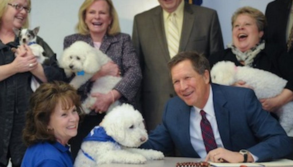 Photo from John Kasich's gubernatorial campaign shows him signing legislation imposing restrictions on puppy mills and large-scale breeders, in 2013