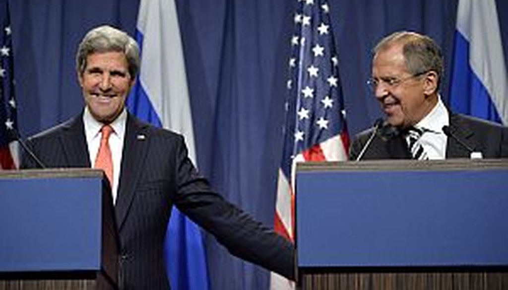 U.S. Secretary of State John Kerry, left, and Russian Foreign Minister Sergei Lavrov reach an agreement  in Geneva on Sept. 14, 2013 for Syria to destroy chemical weapons. (AP Photo)
