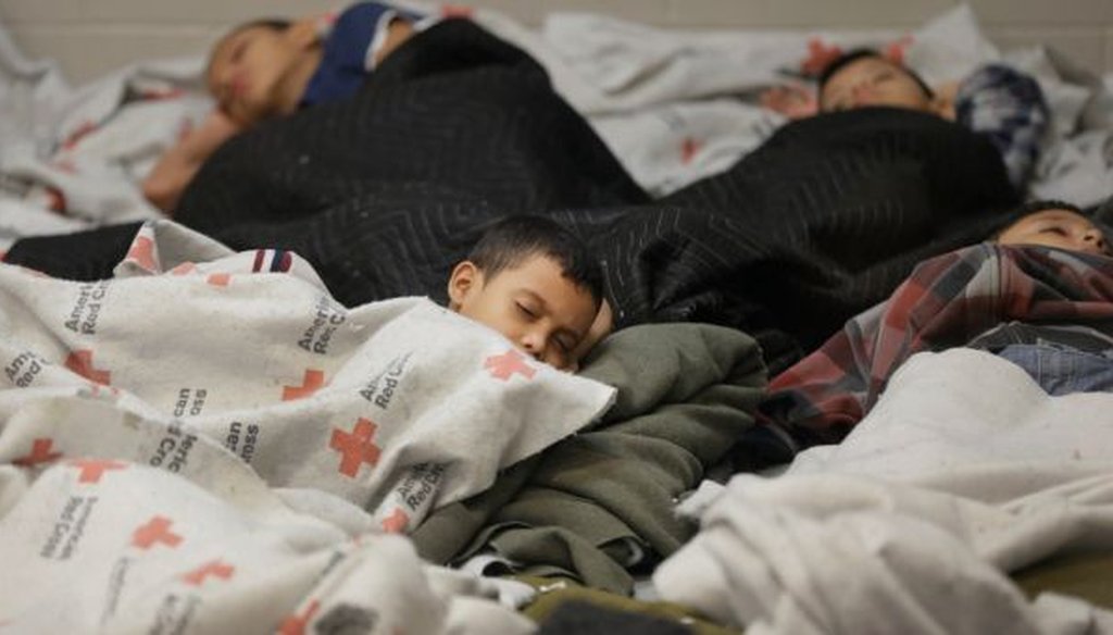 Detainees sleep in a holding cell at a U.S. Customs and Border Protection processing facility on June 18, 2014, in Brownsville,Texas. (AP/Eric Gay) 