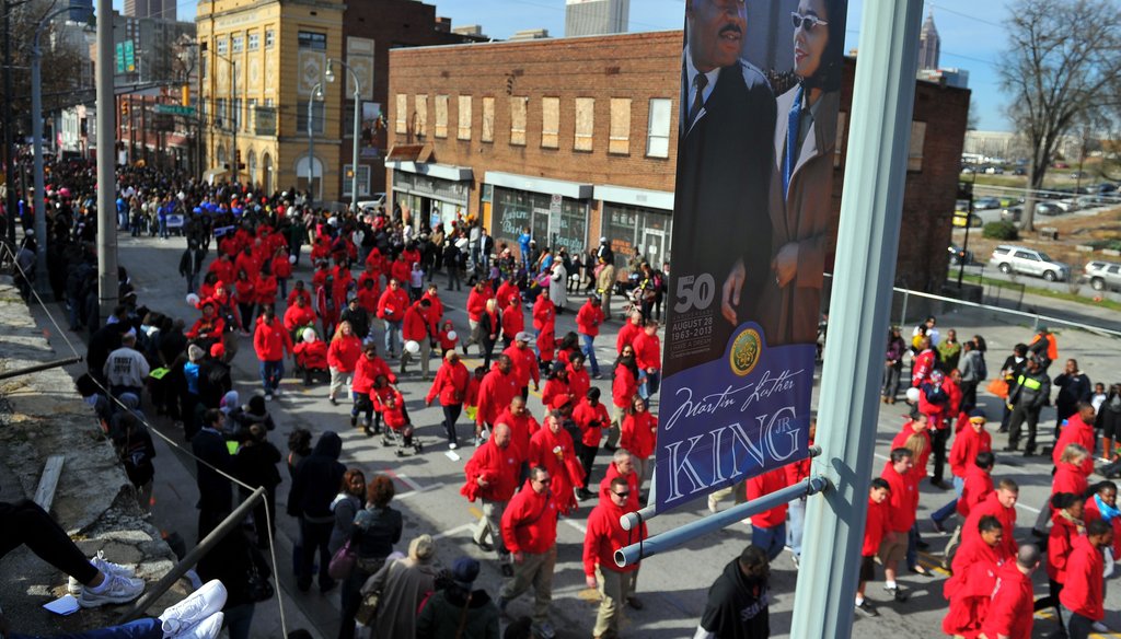 Atlanta, the birthplace of the Rev. Martin Luther King Jr., holds an annual parade to celebrate the federal holiday commemorating his birthday. Here, marchers walk the parade route for the 2013 celebration. Photo credit: Brant Sanderlin/AJC