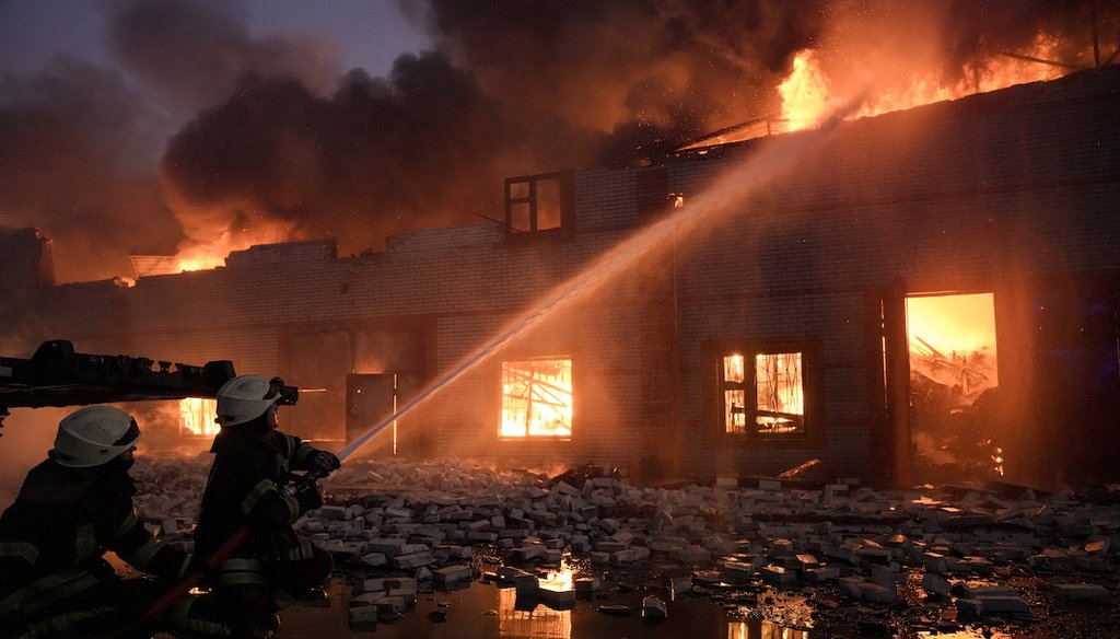 Ukrainian firefighters battle a blaze at a warehouse after a bombing on the outskirts of Kyiv, Ukraine. (AP)