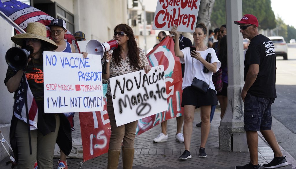 Anti-vaccine mandate protesters rally outside the garage doors of the Los Angeles Unified School District, LAUSD headquarters in Los Angeles. (AP)