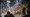 People take cover as a fire work explodes during a protest near the Metropolitan Detention Center in downtown Los Angeles, June 8, 2025 (AP)