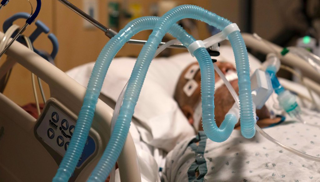 In this Nov. 19, 2020 photo, ventilator tubes are attached to a COVID-19 patient at Providence Holy Cross Medical Center in Los Angeles. California hospitals ended the year on “the brink of catastrophe,” an official said. (AP Photo/Jae C. Hong)