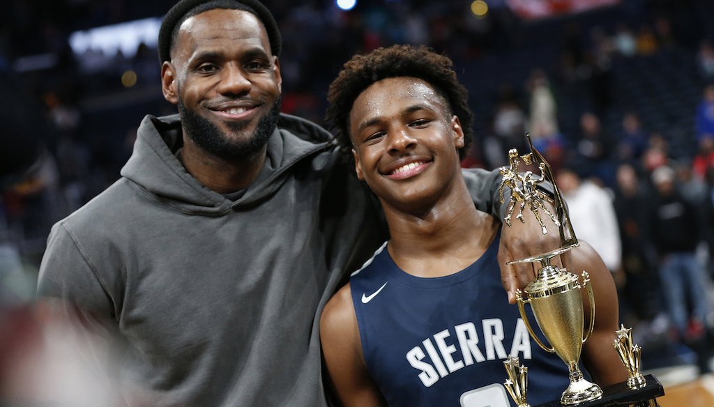LeBron James, left, poses with his son Bronny after Sierra Canyon beat Akron St. Vincent - St. Mary in a high school basketball game, Dec. 14, 2019, in Columbus, Ohio. (AP)