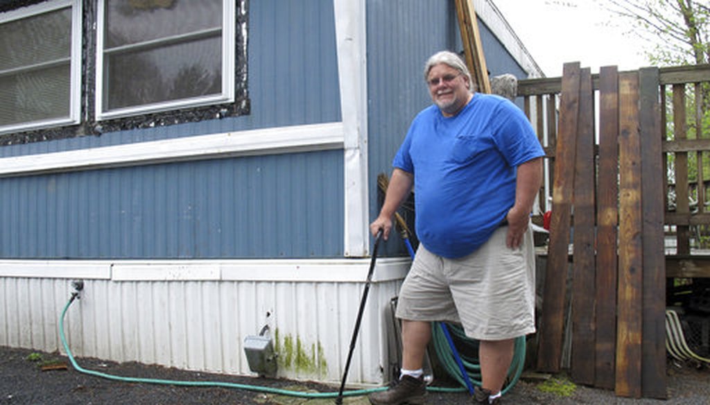 In this May 2, 2017 photo, Todd Alexander poses at his mobile home in Milton, Vt., that he heats with the help of the Low Income Home Energy Assistance Program. (AP)