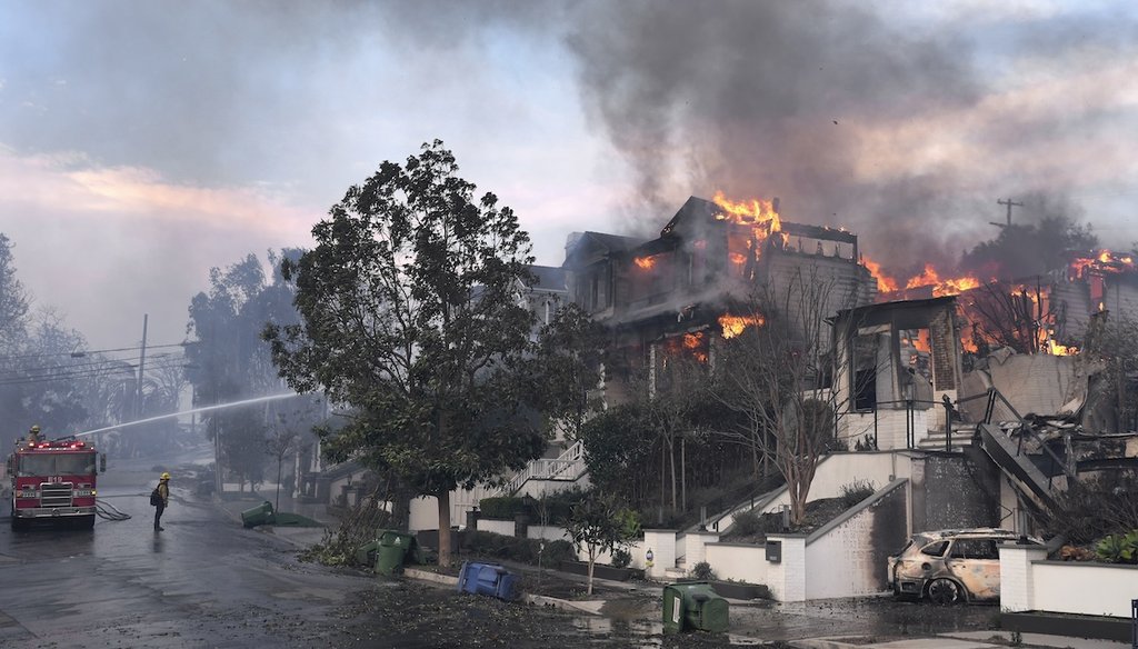 Los Angeles Fire Department firefighters work to extinguish a house fire as the Palisades Fire ravages a neighborhood amid high winds in the Pacific Palisades neighborhood of Los Angeles, Jan. 8, 2025. (AP)
