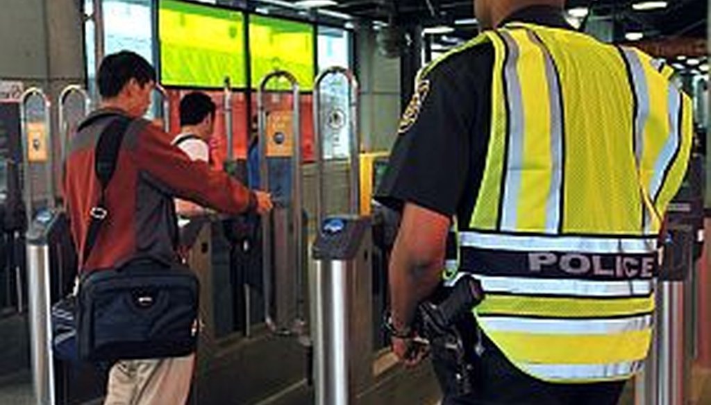 A MARTA police officer patrols Lindbergh Center station. A transit official says the system is getting safer. Crime stats tell a more nuanced story.