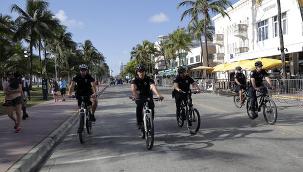 Miami Beach police officers patrol on Ocean Drive March 15, 2020, in Miami Beach, Fla. (AP)