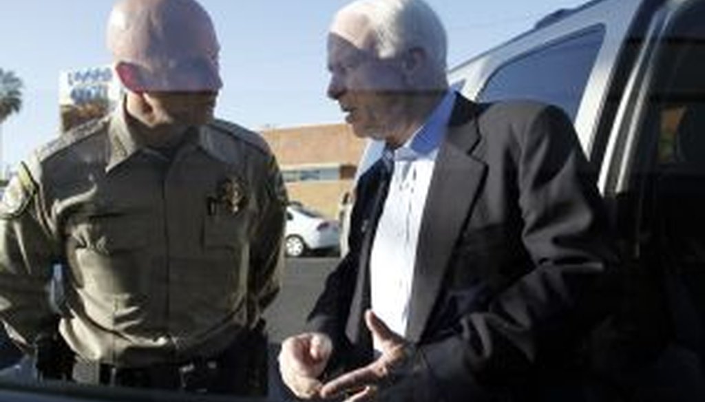 U.S. Sen. John McCain (R-AZ) speaks with Pinal County Sheriff Paul Babeu outside VFW Post #1677 during a campaign stop on April 24, 2010 in Casa Grande, Arizona.