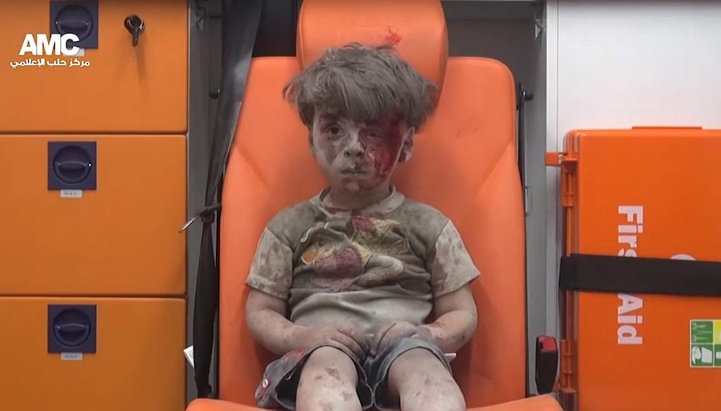 A screenshot from a handout video from Syrian activist group Aleppo Media Center (AMC) shows a 4-year-old boy with a bloodied face sitting in an ambulance after a house was destroyed in an airstrike on Aug. 17, 2016, in Aleppo. (MCT)
