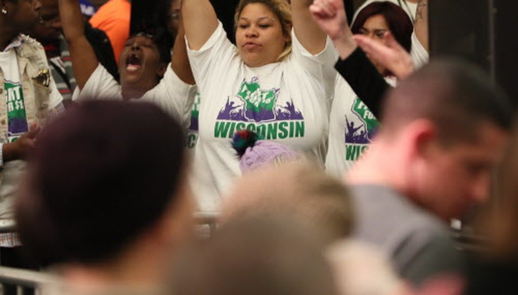 Supporters of raising Wisconsin's minimum wage from $7.25 to $15 an hour demonstrate during an Oct. 22, 2018, University of Wisconsin -- Milwaukee rally featuring Sen. Bernie Sanders. (Michael Sears / Milwaukee Journal Sentinel.)