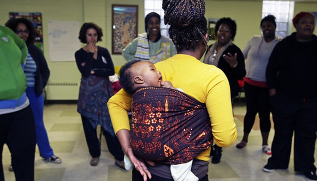 3-month-old Muntasir Mahdi takes a nap on the back of Melissa Marthol at a Doula workshop on North 48th Street in Milwaukee in Nov. 2014.  The training aims to create doulas to assist expectant women. (A. Peterson/Milwaukee Journal Sentinel).