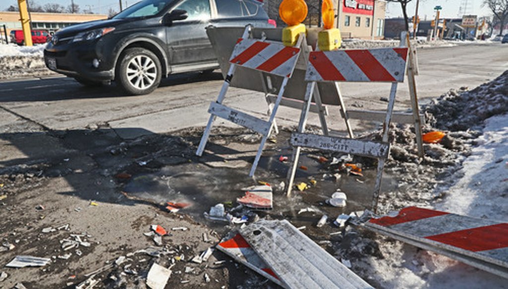 Barricades were placed to try and prevent drivers from hitting a large pothole near 272 E. Capitol Drive in Milwaukee on Feb. 22, 2019. (Michael Sears/Milwaukee Journal Sentinel).