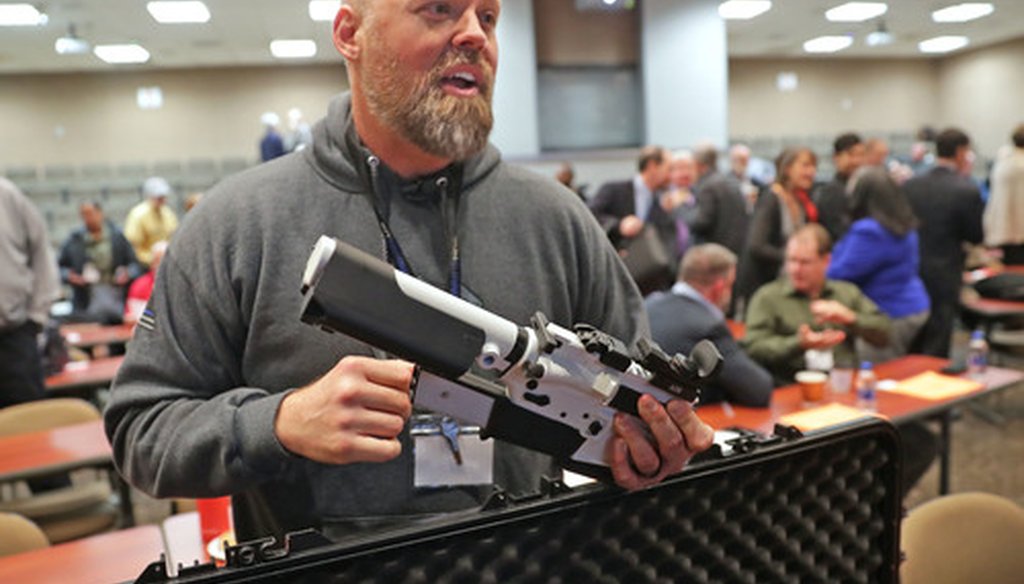 Will Murphy, president of Gun Guardian talks about an AR 15 rifle with a prototype trigger shield during the Firearm Safety Expo at Milwaukee Area Technology College in Oak Creek on Jan. 16, 2019.  (Mike De Sisti / Milwaukee Journal Sentinel).