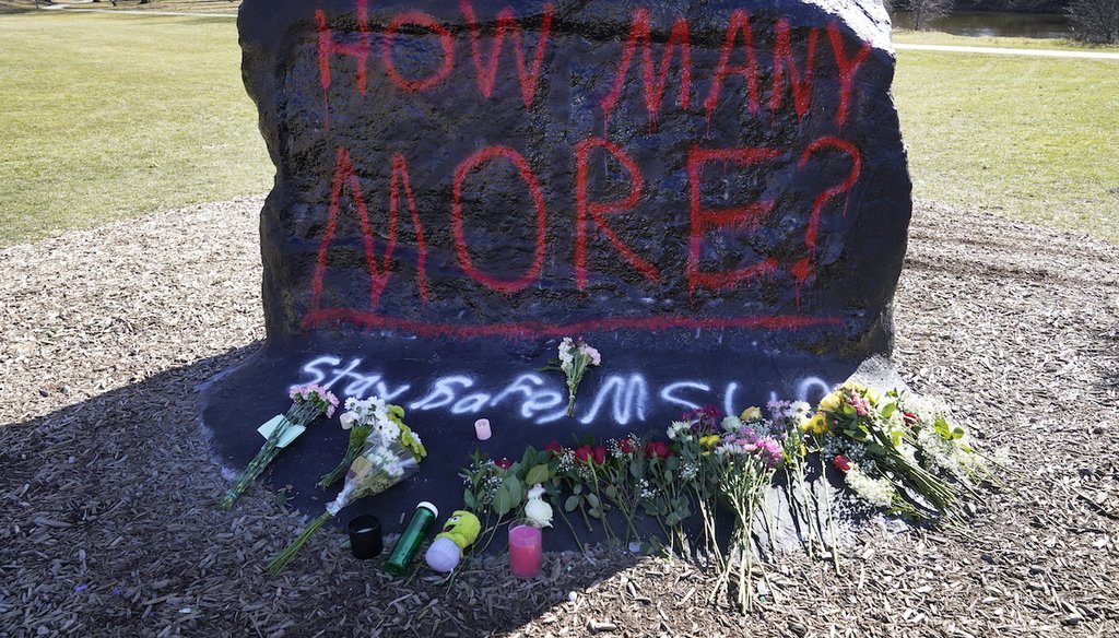 Flowers are displayed at The Rock at Michigan State University, Feb. 14, 2023, in East Lansing, Mich. Police say a gunman killed three people and injured others the previous night. (AP)