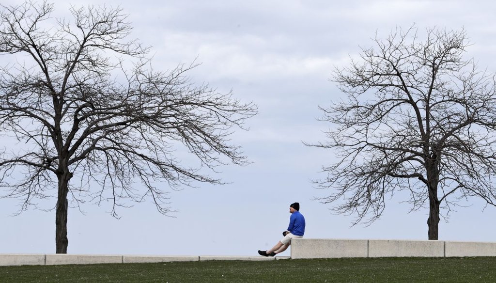 Mike Brown takes sits on a retaining wall and looks out at Lake Erie in Cleveland. (AP)