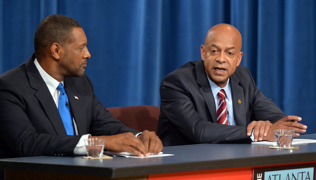 Jeff Mann, left, makes a point during the recent APC debate
