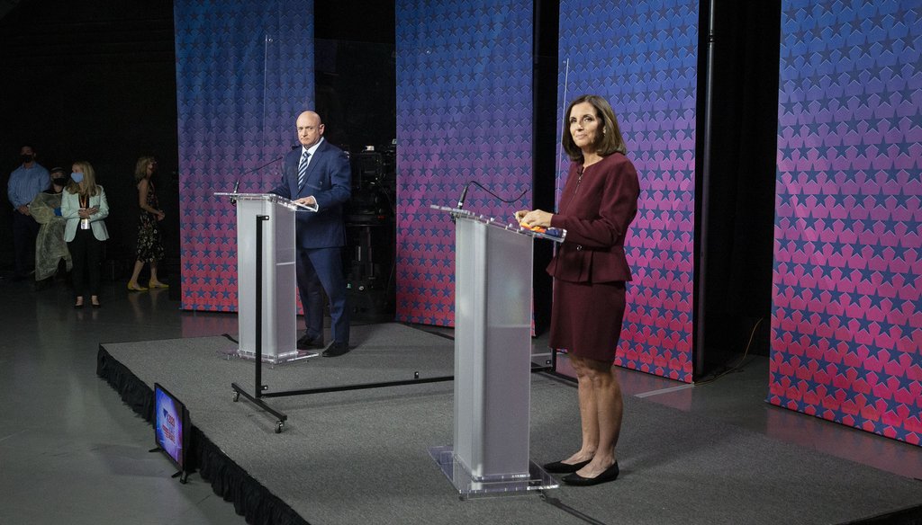 Democratic challenger Mark Kelly, left, and Republican U.S. Sen. Martha McSally are separated by plexiglass as they participate in a debate, Oct. 6, 2020 in Phoenix. (Rob Schumacher/The Arizona Republic via AP, Pool)