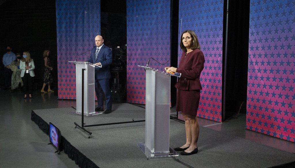 Democratic challenger Mark Kelly, left, and Republican U.S. Sen. Martha McSally are separated by plexiglass as they participate in a debate, Oct. 6, 2020 in Phoenix. (Rob Schumacher/The Arizona Republic via AP, Pool)