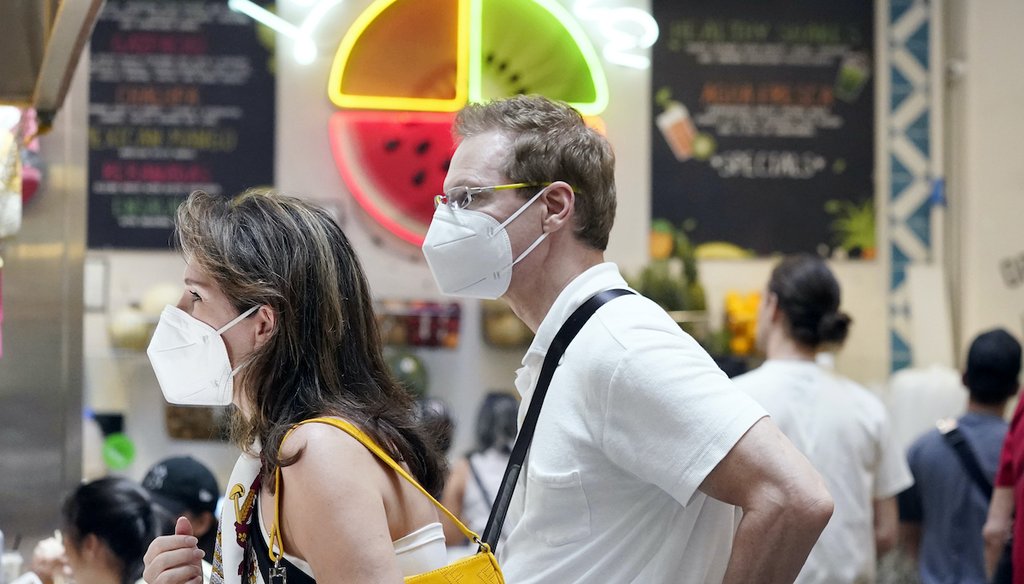 Masked patrons wait to order at a food stand inside Grand Central Market on July 13, 2022, in Los Angeles. Los Angeles County might be imposing a mask-wearing mandate on July 29 if COVID-19 numbers continue to rise. (AP)