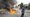 A fire burns as a protester stands across the way from Border Patrol personnel in riot gear and gas masks outside an industrial park in Paramount, Calif., on June 7, 2025. (AP)