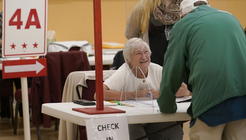 An election worker assists a voter at a polling place in Attleboro, Mass., on Sept. 6, 2022. (AP)