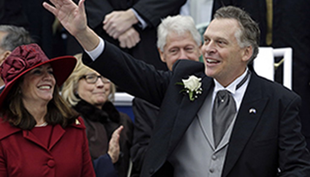 Gov. Terry McAuliffe, shown at his inauguration, with his wife, Dorothy. Behind them are former President Bill Clinton and former Secretary of State Hillary Clinton. 