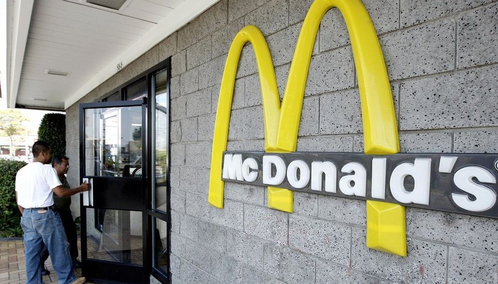 Two customers walk inside one of the 14,000 McDonald's restaurants in the country. Atlanta-based civil rights activist, the Rev. Markel Hutchins, says there are twice as many gun stores in the United States than McDonald's.