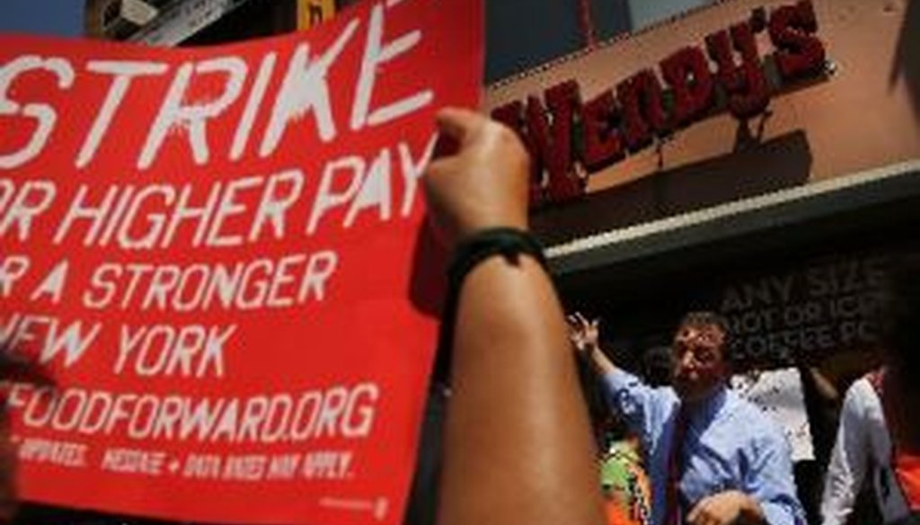 New York City Councilman Brad Lander speaks to employees at Wendy's fast-food restaurant during a demonstration outside of one of the restaurants to demand higher pay and the right to form a union on July 29, 2013, in New York City.