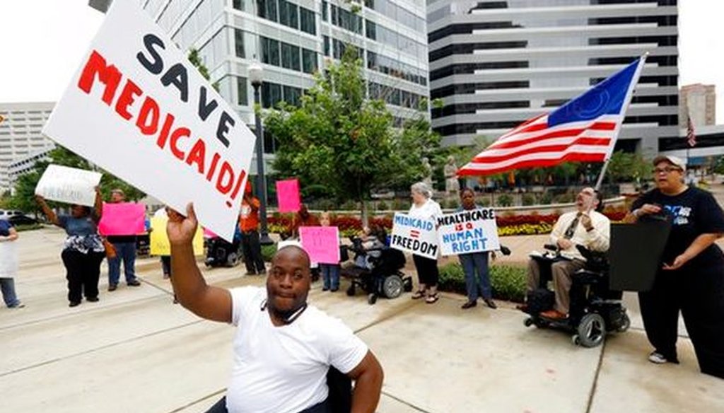 Mario Henderson leads chants of "save Medicaid" outside a Jackson, Miss., building that houses offices of Sen. Thad Cochran, R-Miss., on June 29, 2017.l (AP/Rogelio V. Solis)