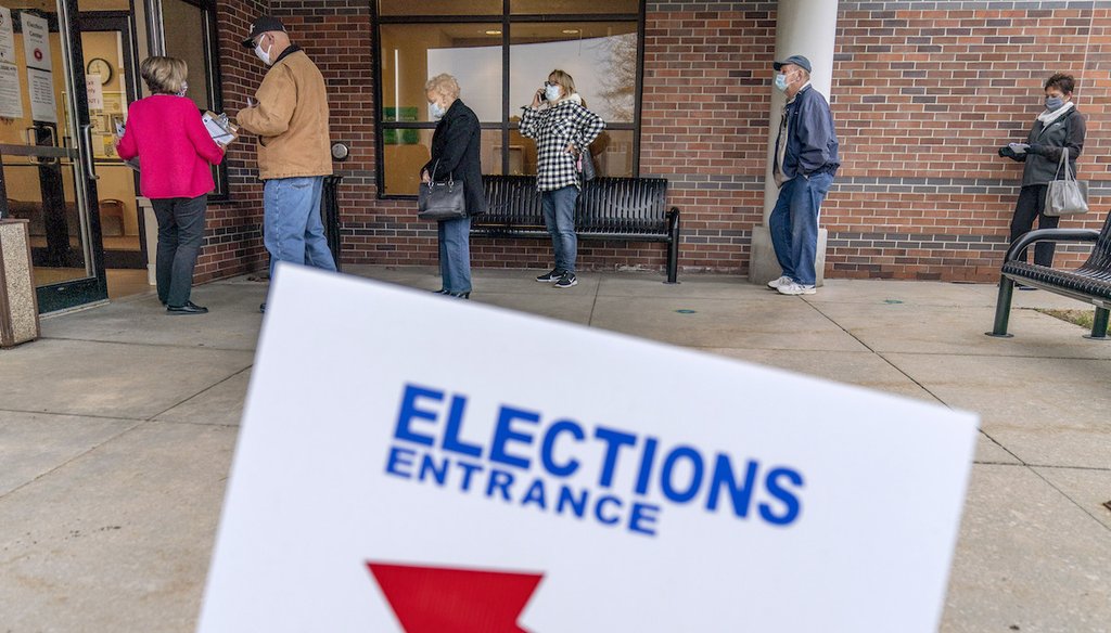 Voters line up as the doors open to the Election Center for absentee early voting for the general election in Sterling Heights, Mich., Oct. 29, 2020. (AP)