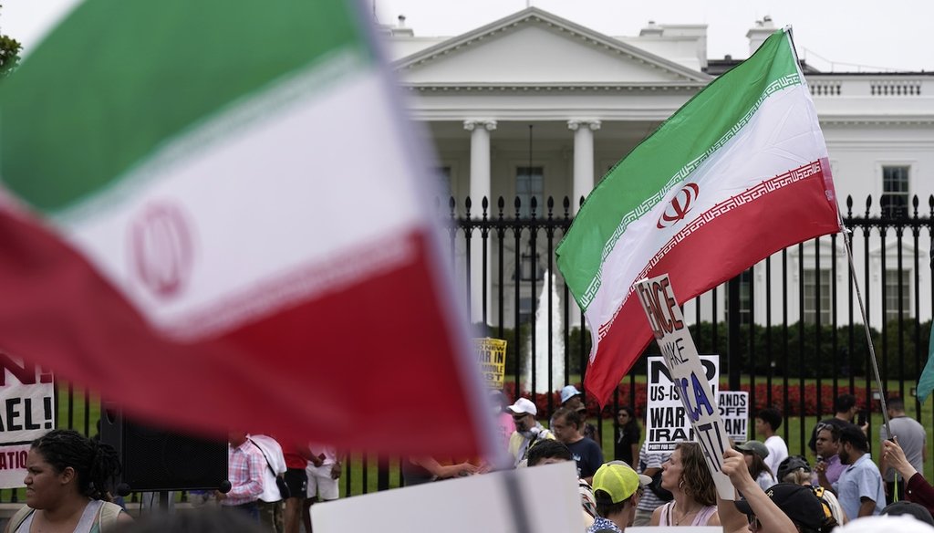 Demonstrators carry signs and wave the Iranian flag as they rally outside the White House, June 22, 2025, in Washington, to protest the U.S. military strike on three sites in Iran. (AP)