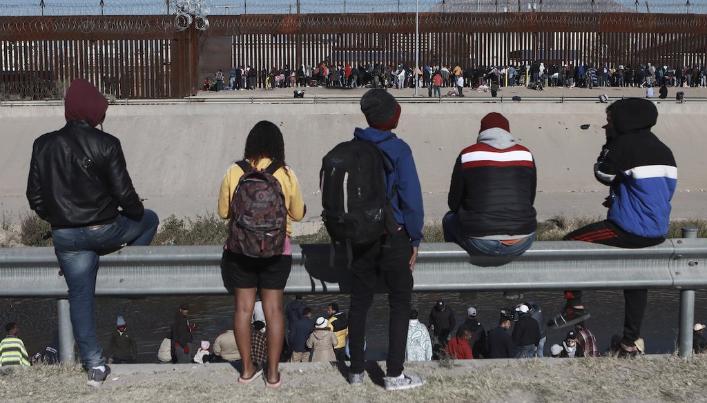 Migrants watch others stand next to the border wall in Ciudad Juarez, Mexico, Dec. 21, 2022, on the other side of the border from El Paso, Texas. (AP)