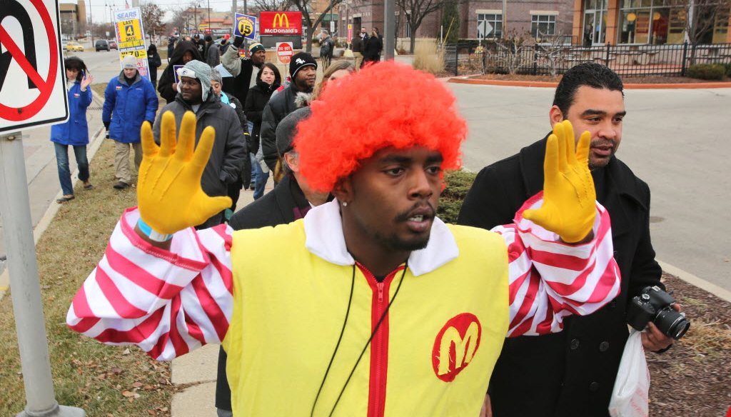 Fast food workers and supporters, including a man dressed as Ronald McDonald, rallied for a higher minimum wage in the Milwaukee suburb of Glendale on Dec. 4, 2014. (Mike De Sisti photo)