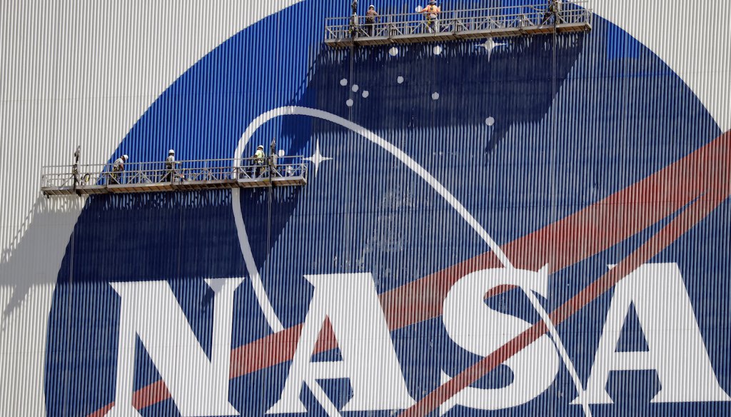 In this file photo, workers at the Kennedy Space Center in Cape Canaveral, Fla., spruce up the NASA logo. (AP)