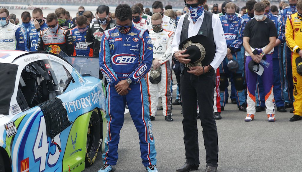 Team owner Richard Petty, right, stands next to driver Bubba Wallace during the national anthem prior to the start of the NASCAR Cup Series at the Talladega Superspeedway in Talladega, Ala., Monday, June 22, 2020. (AP Photo/John Bazemore)