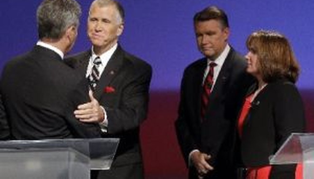 North Carolina GOP senatorial candidates Greg Brannon, left, and Thom Tillis shake hands as Mark Harris and Heather Grant, right, look on at a debate on April 28, 2014.